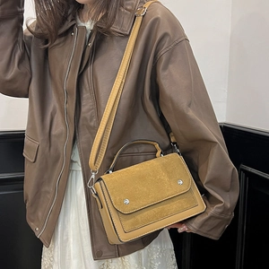Retro mustard yellow square handbag with leather stitching and metal rivets