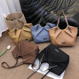 Minimalist ruched tote bags in multiple colors like tan and navy blue for daily commute