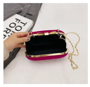 Internal view of velvet evening bag with gold chain and black lining fabric