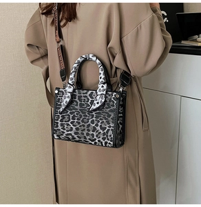Leopard print crossbody bag with silk scarf detail and stylish wide strap on model