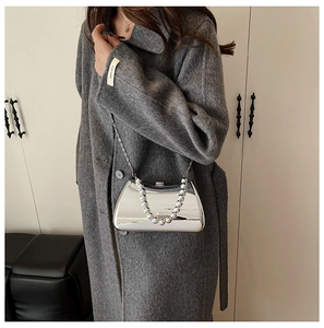 Detail of silver mirror box bag with acrylic beaded handle and slim metal chain