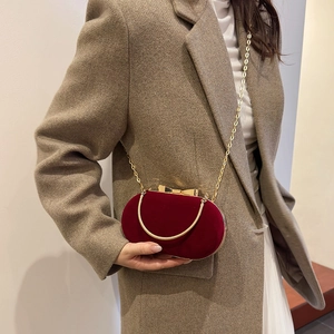 Elegant burgundy velvet evening clutch bag with gold chain strap and metal top handle