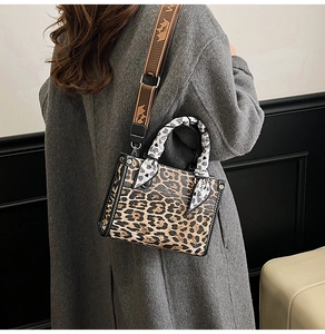 Fashionable leopard print handbag with a jacquard strap and heart silk scarf detail