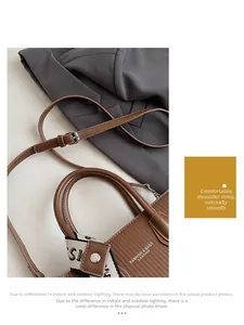 Detail of brown pleated leather handbag with logo strap and adjustable shoulder strap
