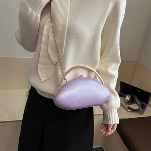 Detail of lavender acrylic oval evening bag with gold chain and shell texture