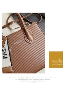 Detail of brown vertical stripe leather tote bag with dual shoulder straps and handles