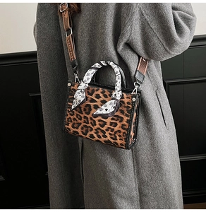 Detail of leopard print handbag with silk scarf handle and wide jacquard shoulder strap