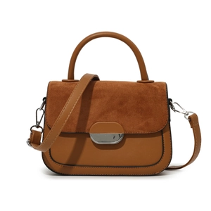 Brown patchwork saddle bag with suede flap, silver lock and top handle for women