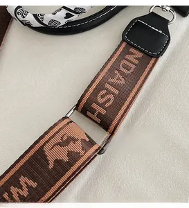 Detailed close-up of premium silver metal hardware and jacquard strap on a handbag