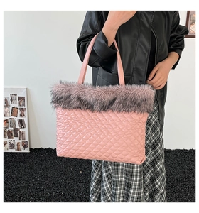 Detailed shot of pink quilted tote bag with grey faux fur trim and matching handle