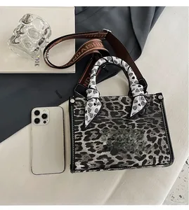 Detailed top view of leopard print tote bag with printed scarf and wide canvas strap