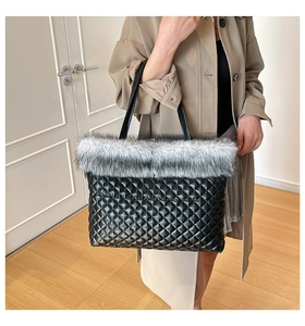 Close-up of quilted tote bag featuring grey faux fur trim and black diamond pattern