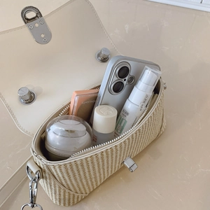 Chic cream woven flap handbag with silver hardware showing interior storage capacity