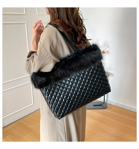 Detail view of black quilted tote bag with faux fur trim and elegant diamond stitching