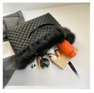 Detail view of black quilted tote bag capacity with faux fur trim and daily essentials