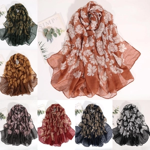 Detail shot of lightweight floral print scarves in multiple colors on a clean white background