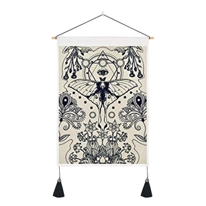 Bohemian tapestry featuring a black moth and mystic eye design on cream canvas fabric