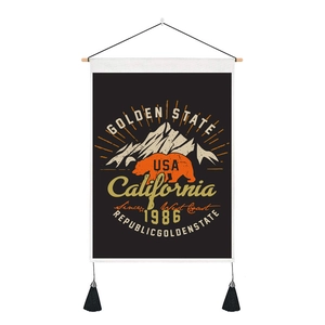 Detail of vintage California wall tapestry featuring a golden state bear and tassels