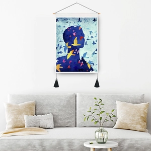 Nordic wall hanging tapestry featuring blue silhouette with colorful birds and black tassels