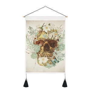 Close-up of retro skull tapestry with realistic flowers and wooden hanging rod
