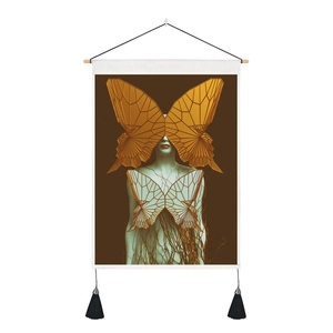 Close-up of surrealist wall tapestry with golden butterfly art and black fringe tassels