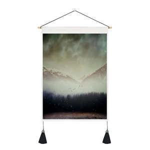 Detail of Nordic mountain landscape wall tapestry with wooden rod and black tassels