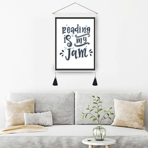 Minimalist wall hanging decor with Reading is my Jam text and black tassels
