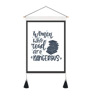 Detail of canvas wall hanging featuring literary quote and decorative black tassels