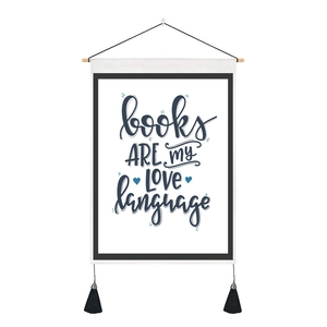 Detail of wooden hanger frame wall art with blue typography and black decorative tassels