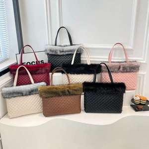 Quilted tote bag with faux fur trim in multiple colors displayed on white pedestals
