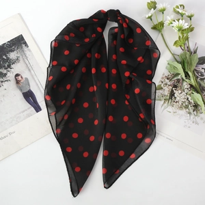 Lightweight black chiffon scarf with red polka dot pattern displayed on white surface