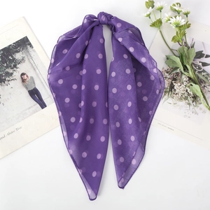Close-up of purple polka dot chiffon scarf with soft knot and translucent fabric texture