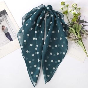 Detailed view of dark green polka dot chiffon hair scarf with elegant long ribbon tails