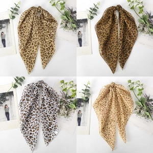 Detailed view of four leopard print chiffon scarves in various colors on white background