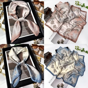 Detailed view of floral silk scarves in pink and blue grey with elegant satin finish