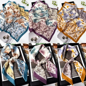 Detailed views of blue floral silk scarf showing elegant prints and knotted textures