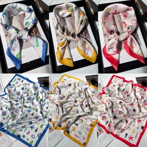 Detailed pattern view of silk square scarf featuring starfish and seashells marine print