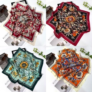 Detail of four silk scarves with starfish shell and floral prints for seaside sun protection