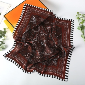 Detail of 70cm square silk scarf featuring bohemian paisley patterns and striped borders