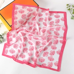 Detailed view of pink shell pattern silk scarf with satin finish and elegant folds