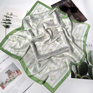 70cm square silk scarf featuring nautical shell patterns and green borders on white fabric