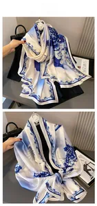 Detail of vintage peony and wave print silk scarf with blue border and glossy finish