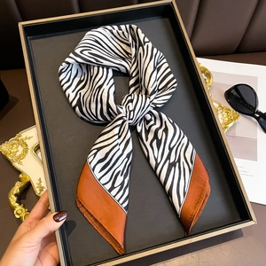 Elegant zebra print silk square scarf with caramel border and glossy finish for women