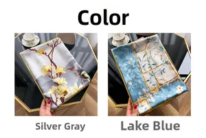 Detail of silk scarves in silver grey and lake blue with magnolia and floral prints