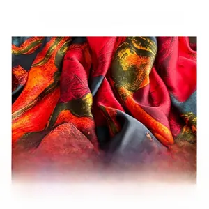 Macro detail of silk scarf showing rose print texture and soft flowing satin fabric