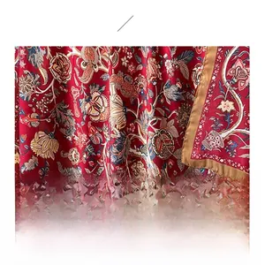 Detailed macro view of red satin fabric featuring intricate vintage floral patterns