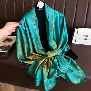 Deep green silk-like scarf with peacock feather print and camellia accessory
