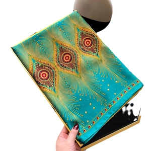 Peacock feather print faux silk scarf elegantly displayed in a gold-edged gift box