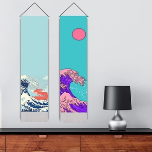 Japanese style ukiyo-e wave wall scrolls set with tassels hanging on a white wall