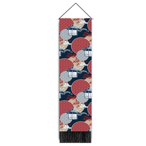 Close-up of Japanese tapestry with traditional landscape patterns and black tassels